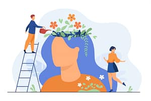 Tiny people and beautiful flower garden inside female head